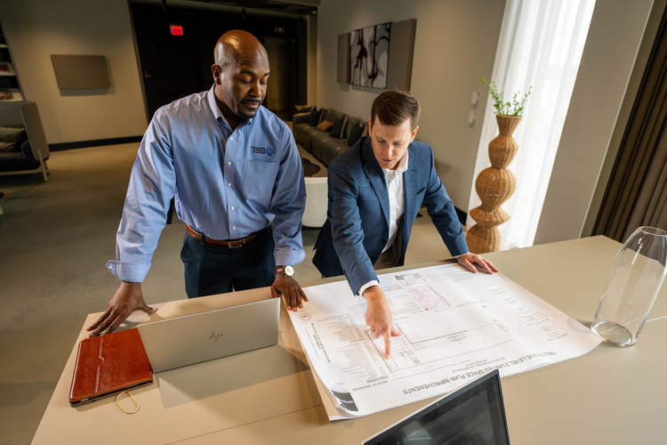 Mallory & Evans team members reviewing project blueprints