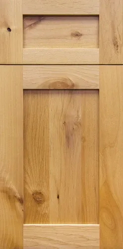 Close-up of wooden cabinetry door with natural wood grain and knots in a light finish.