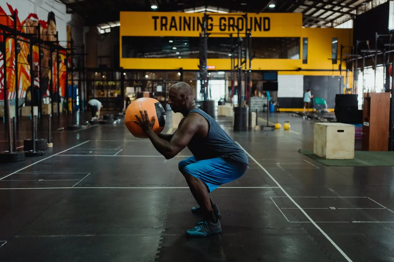 middle-age-man-doing-squats-with-a-ball