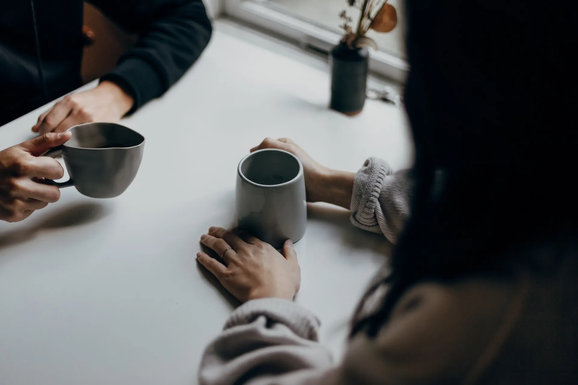woman-in-black-long-sleeve-shirt-holding-black-ceramic-mug