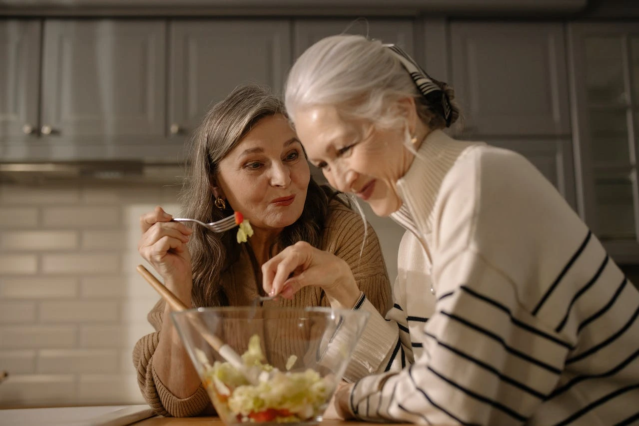 two-elderly-women-eating-happy
