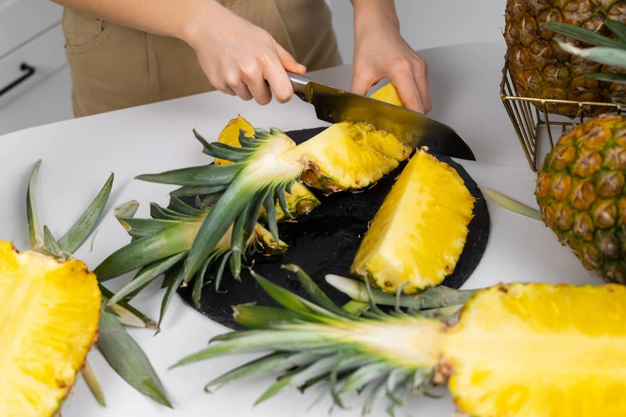 woman-cutting-a-pineapple