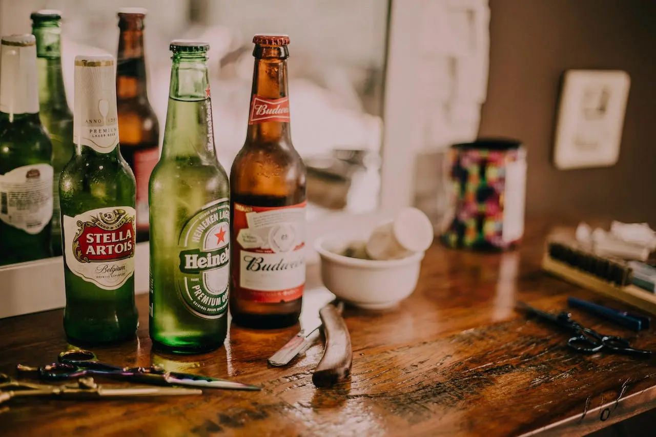 three-assorted-beverage-bottles-on-brown-wooden-table