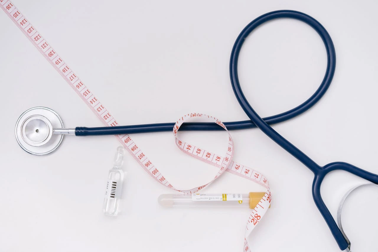stethoscope-and-tape-measure-on-white-surface