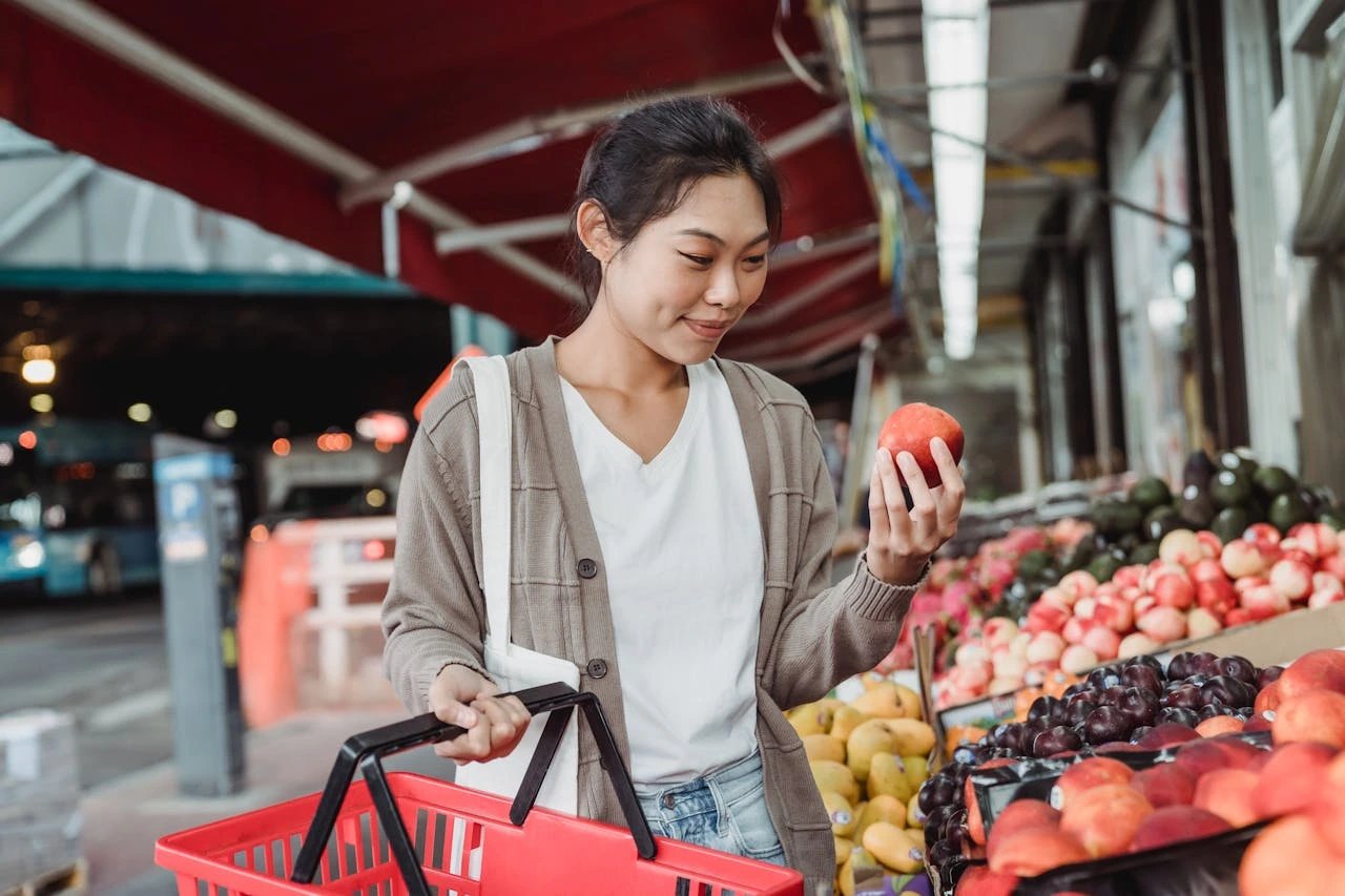 woman-buying-fruits-at-a-market
