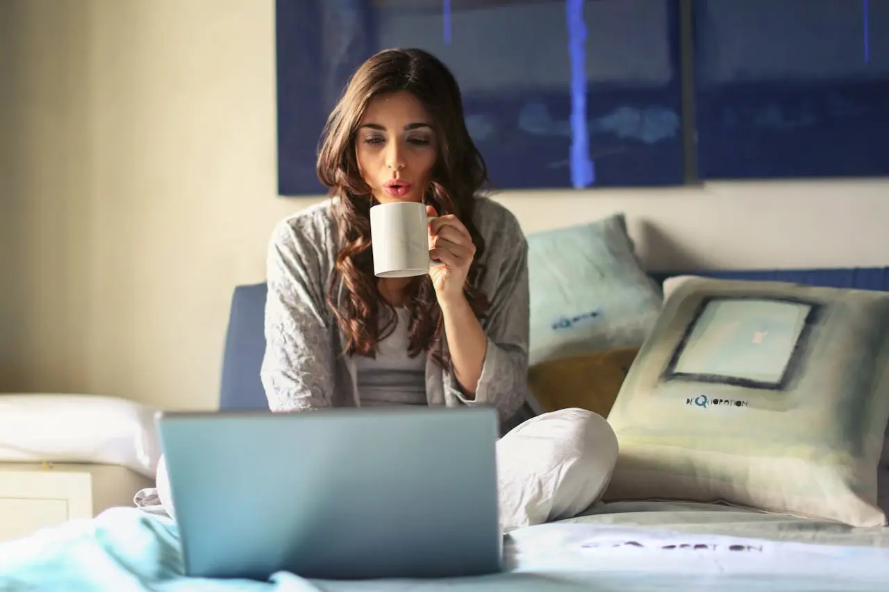 Woman drinking a cup of tea at bed