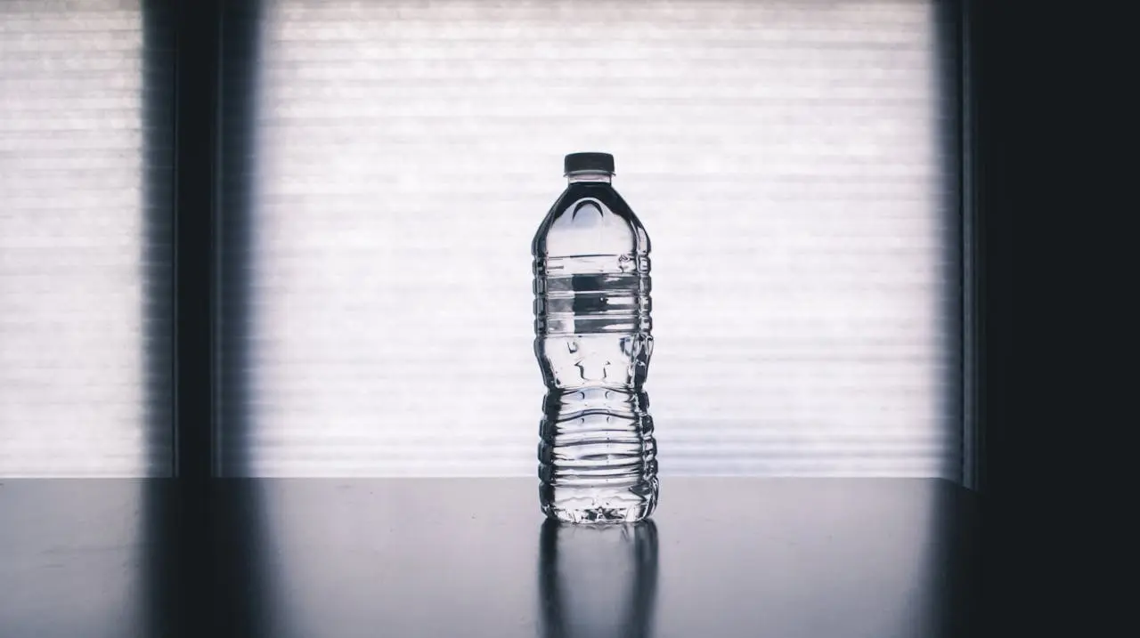 a bottle of water in the middle of a black table
