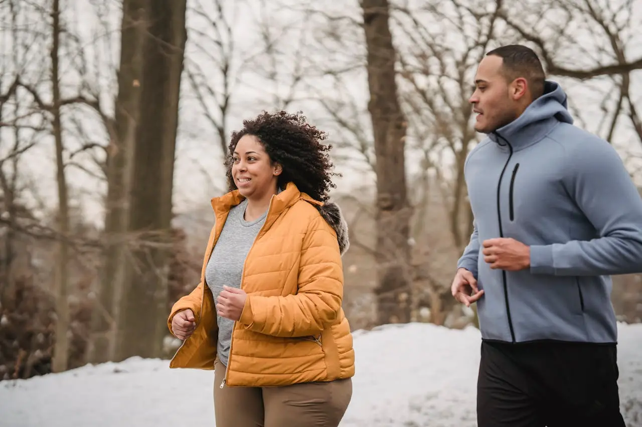 Man and woman jugging on a snowy day.