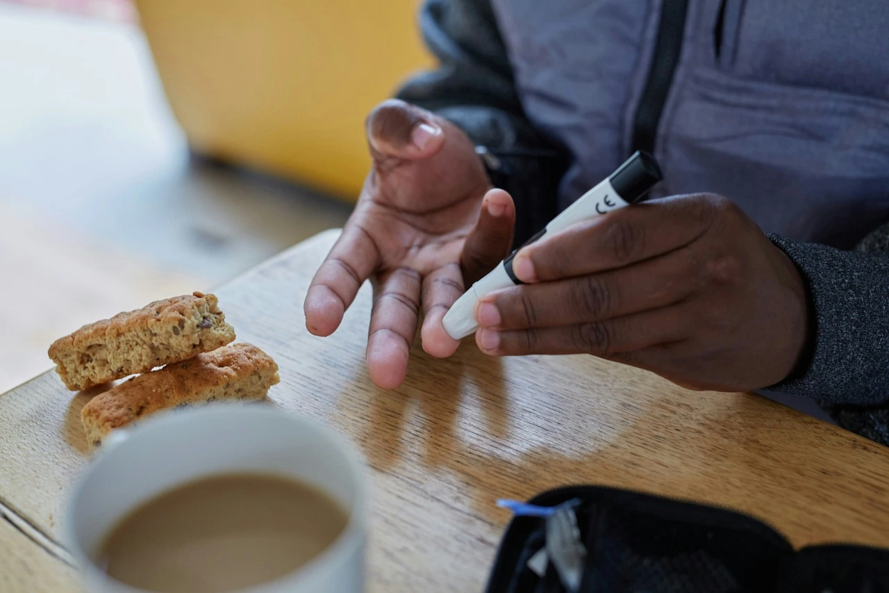 A person doing a finger stick test for blood glucose