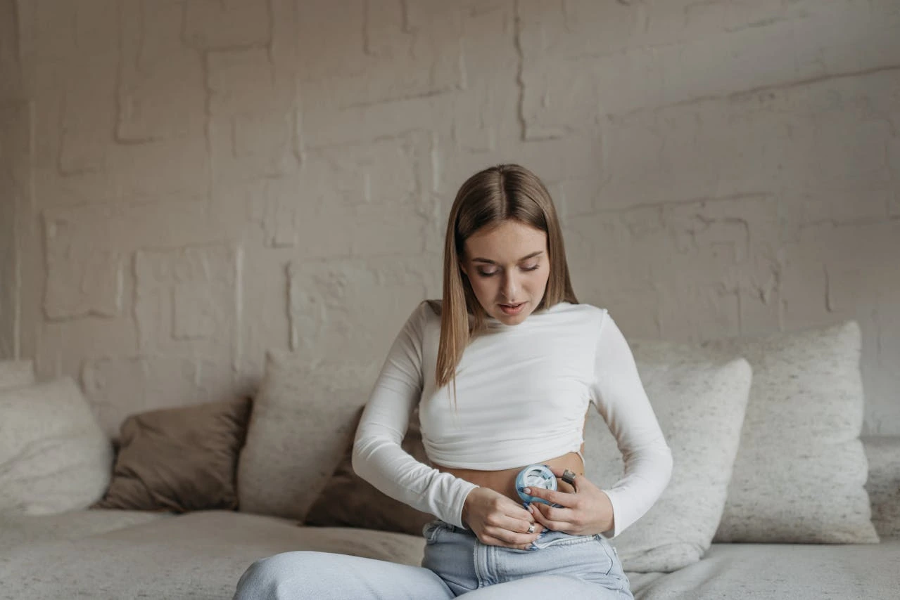 A woman adjusting an insulin pump