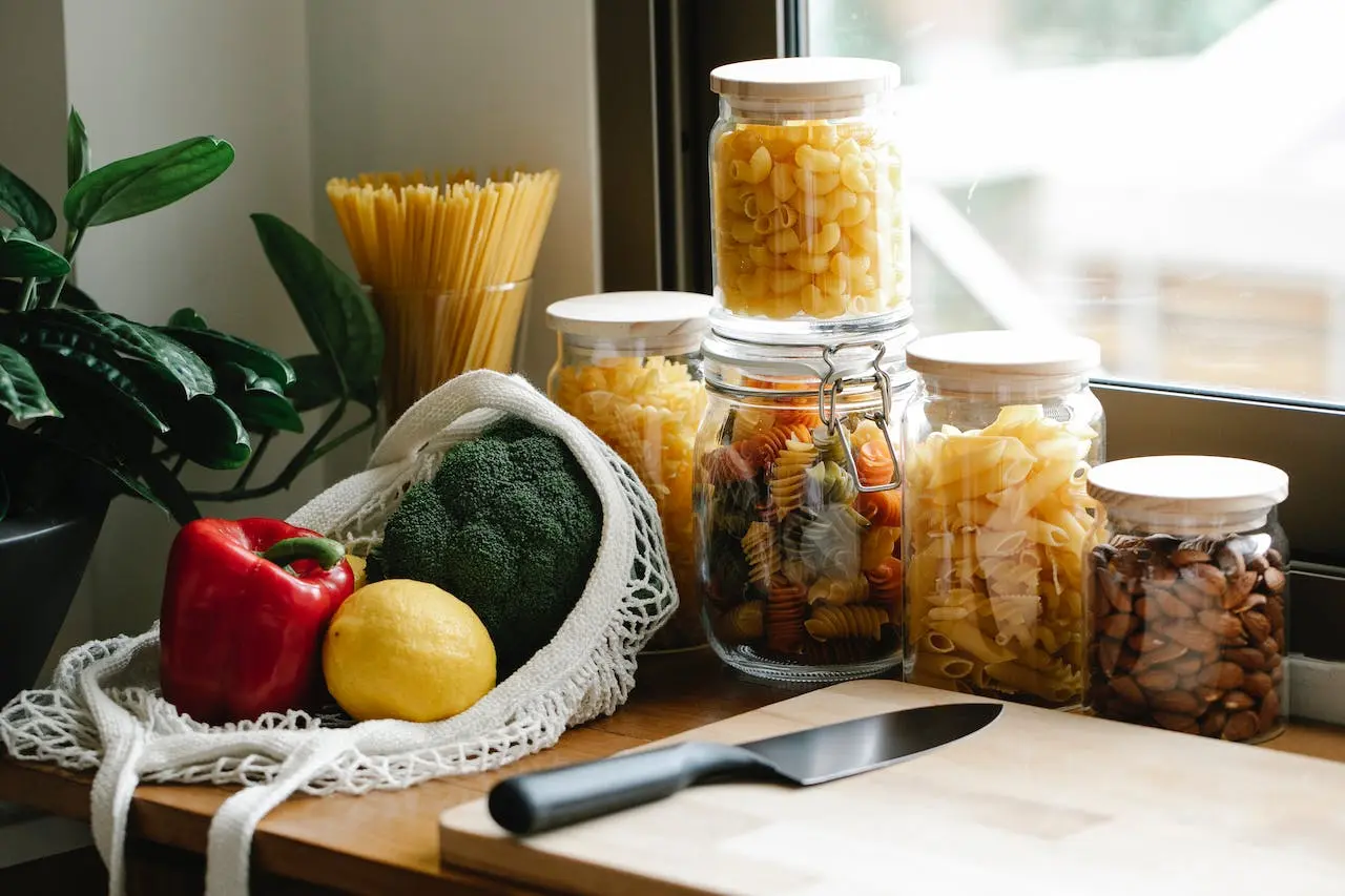 group-of-vegetables-in-a-table-with-pasta-on-jars