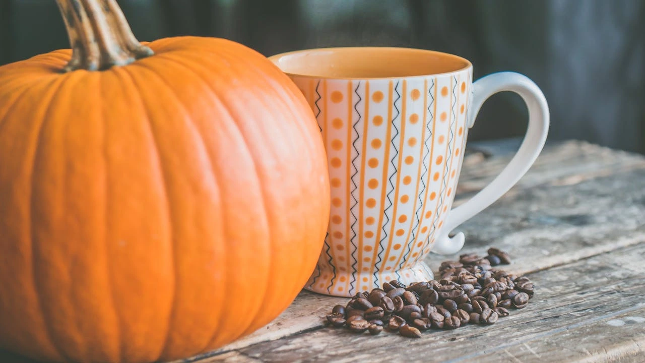 A pumpkin and a coffee mug