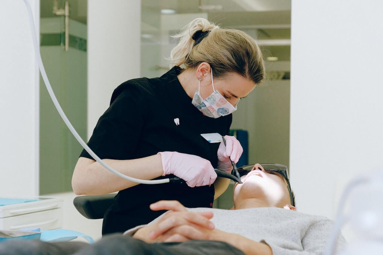 Dental professional performing dental procedure on patient in clinic