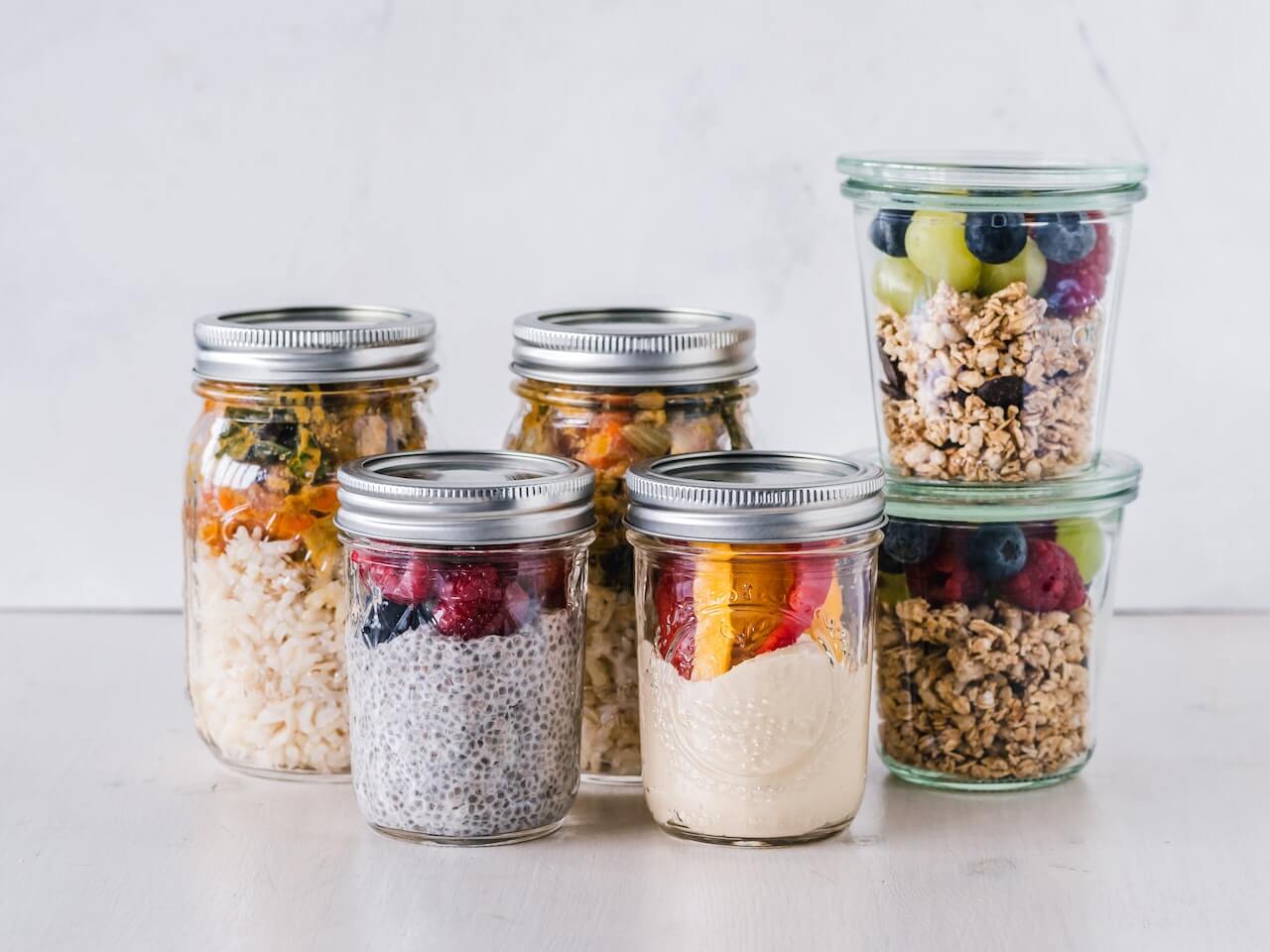 Healthy breakfast jars with chia pudding, fruits, and granola