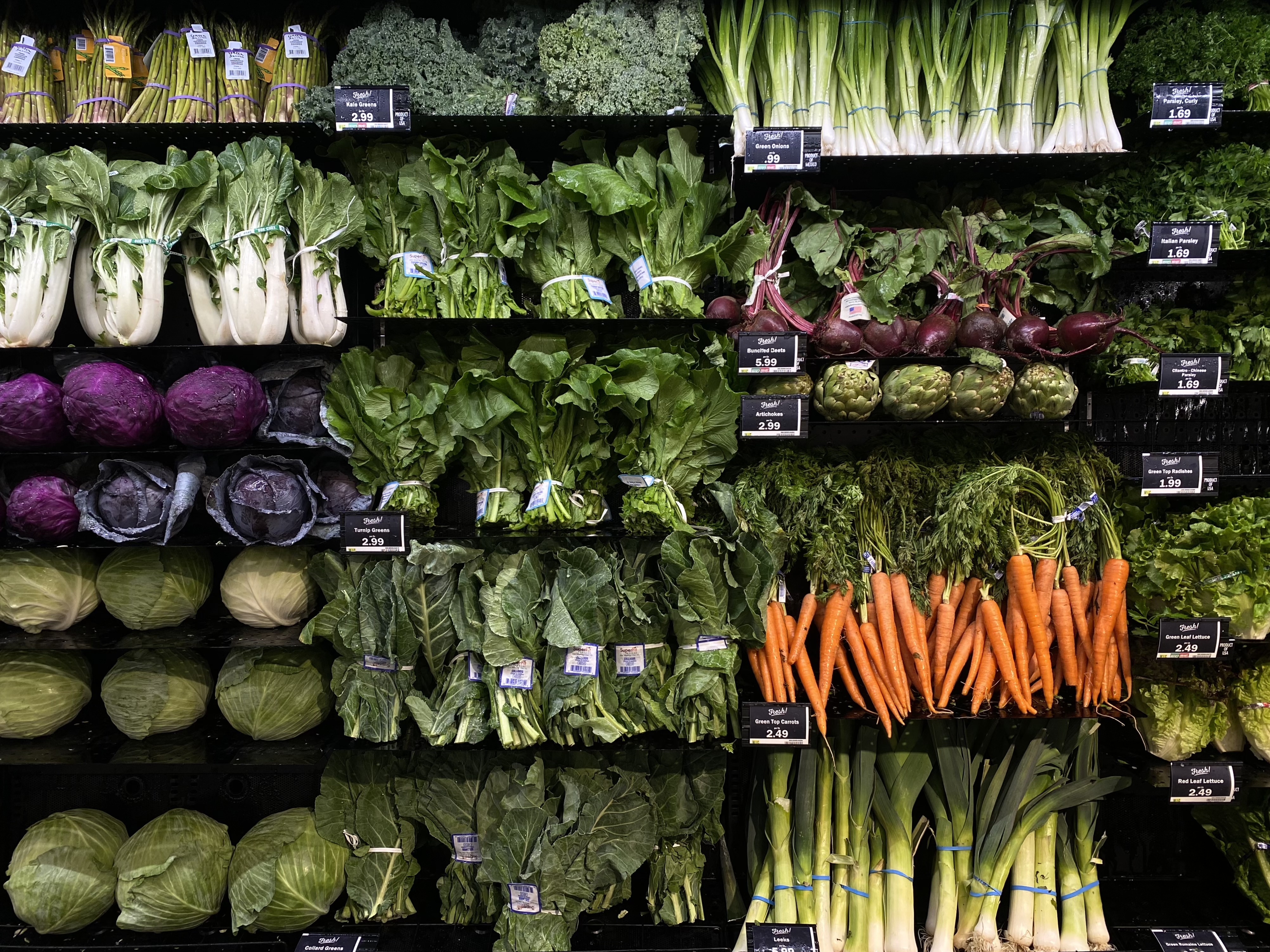 Wall of produce at a grocery store.