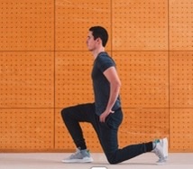 Person doing a forward lunge exercise against an orange textured wall