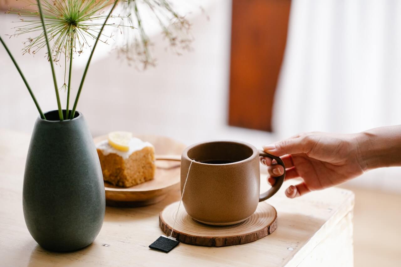 Cozy morning scene with tea, cake, and dried flowers