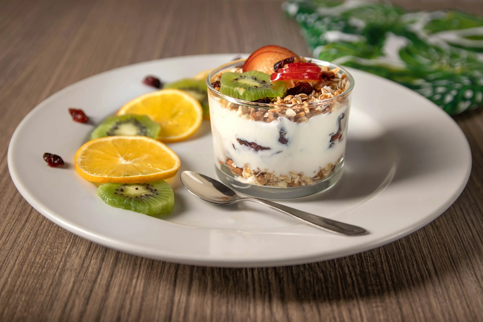 Yogurt parfait with granola, fruits, and nuts in a glass
