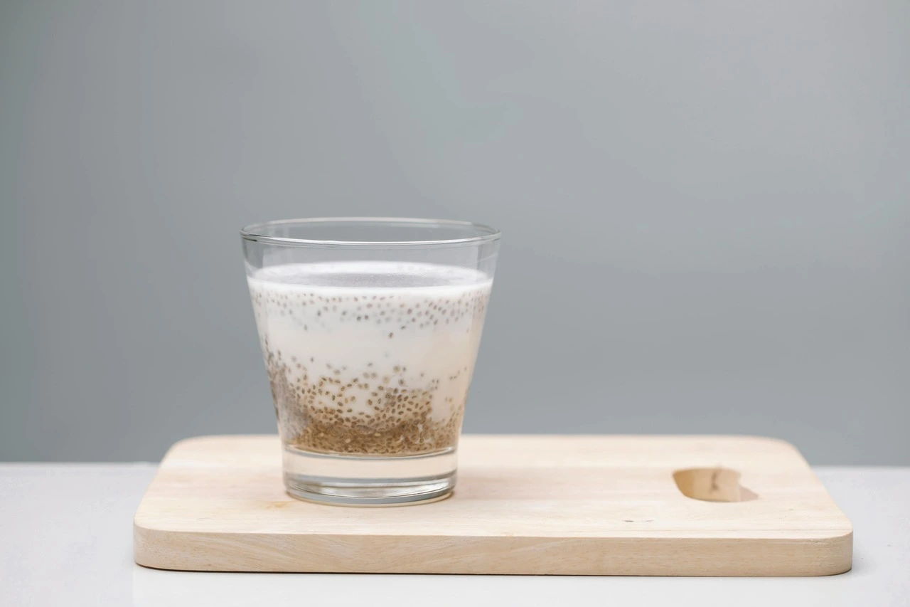 Chia seed pudding with white and brown layers in a clear glass
