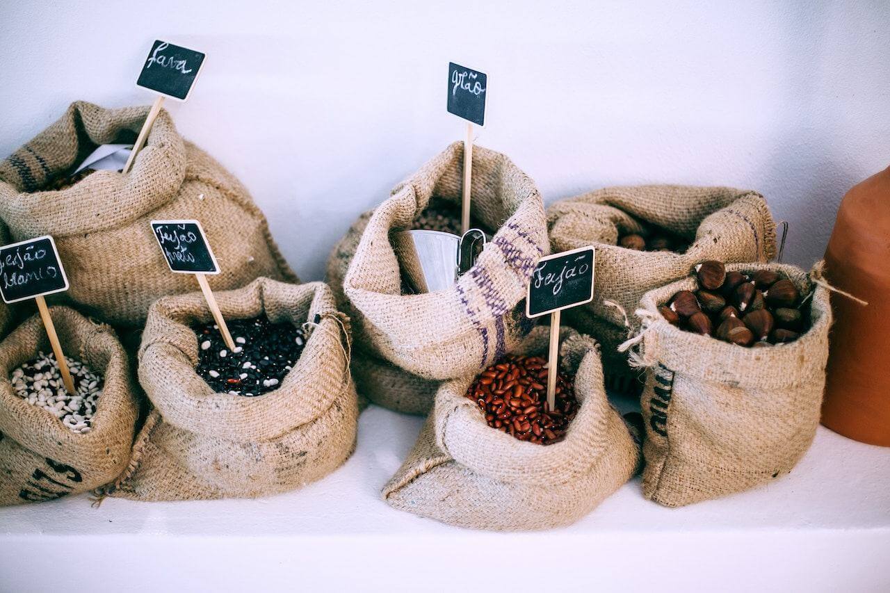 Burlap sacks filled with different types of coffee beans