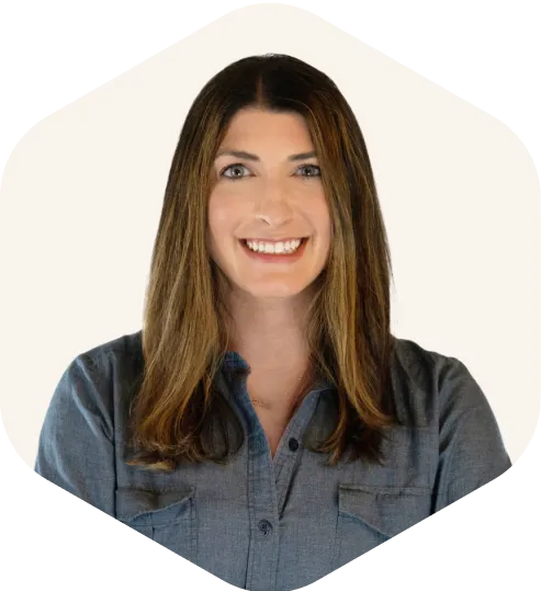 Smiling professional woman in blue shirt with long brown hair