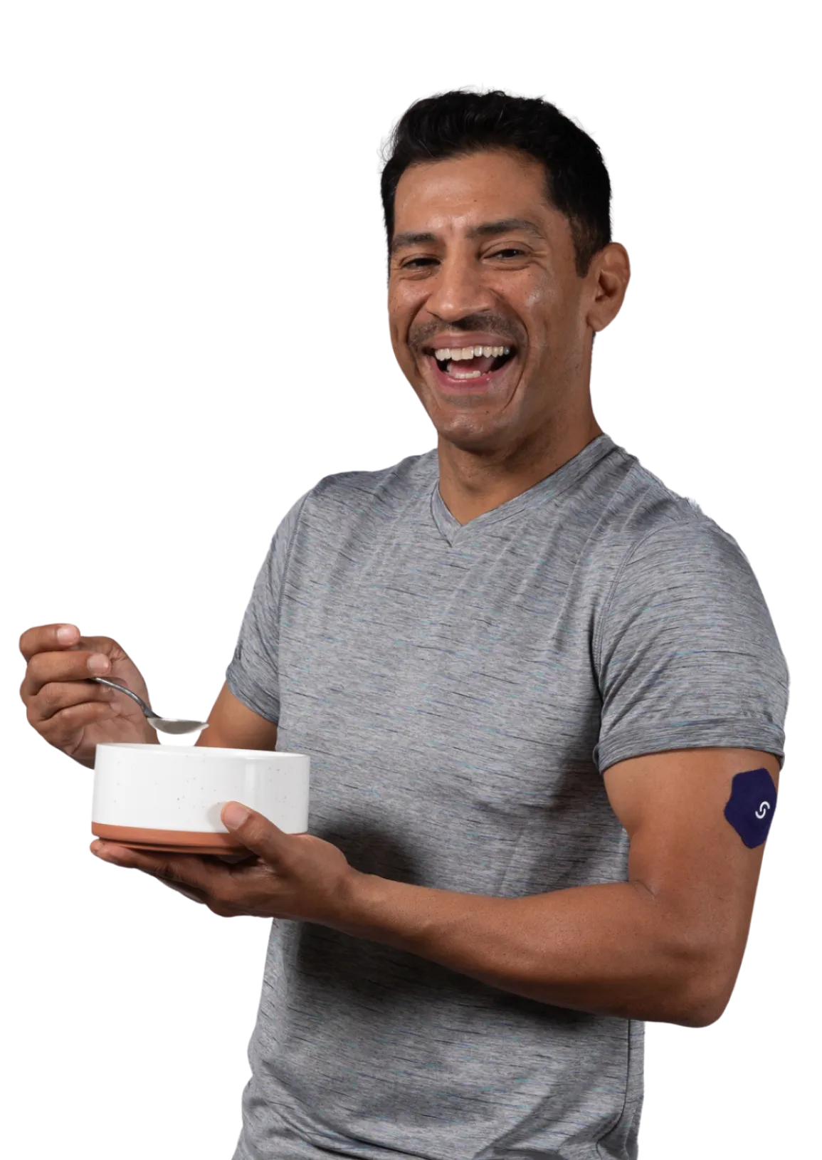 Smiling person in gray shirt holding white bowl and spoon
