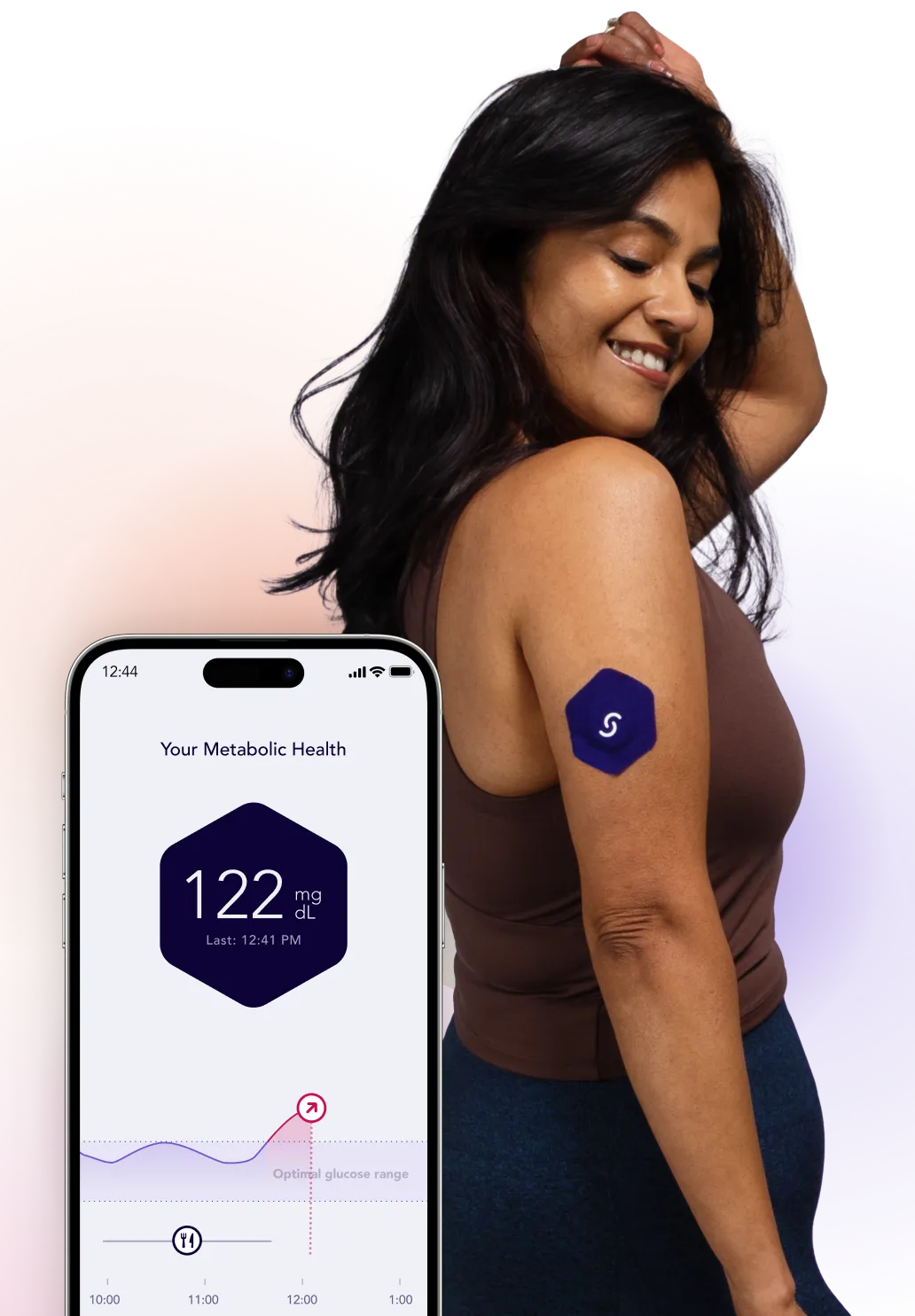 Woman wearing metabolic health tracker monitoring glucose levels on smartphone