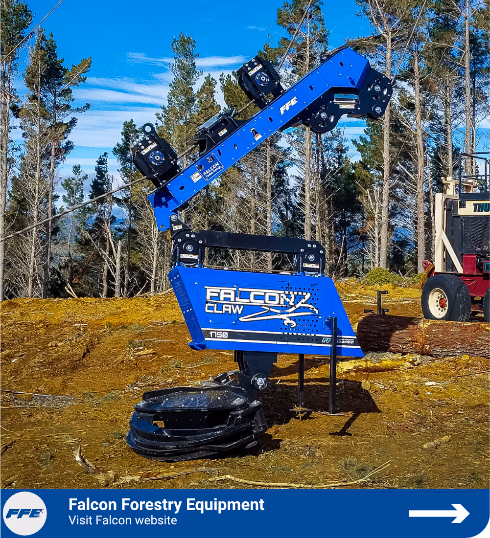 Blue Falcon Claw forestry equipment with mechanical arm on forest ground under clear blue sky.