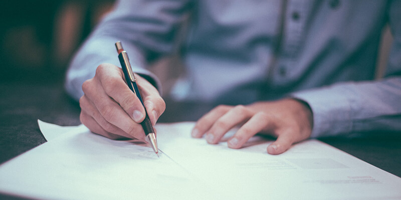 A man fills out an invoice for a client