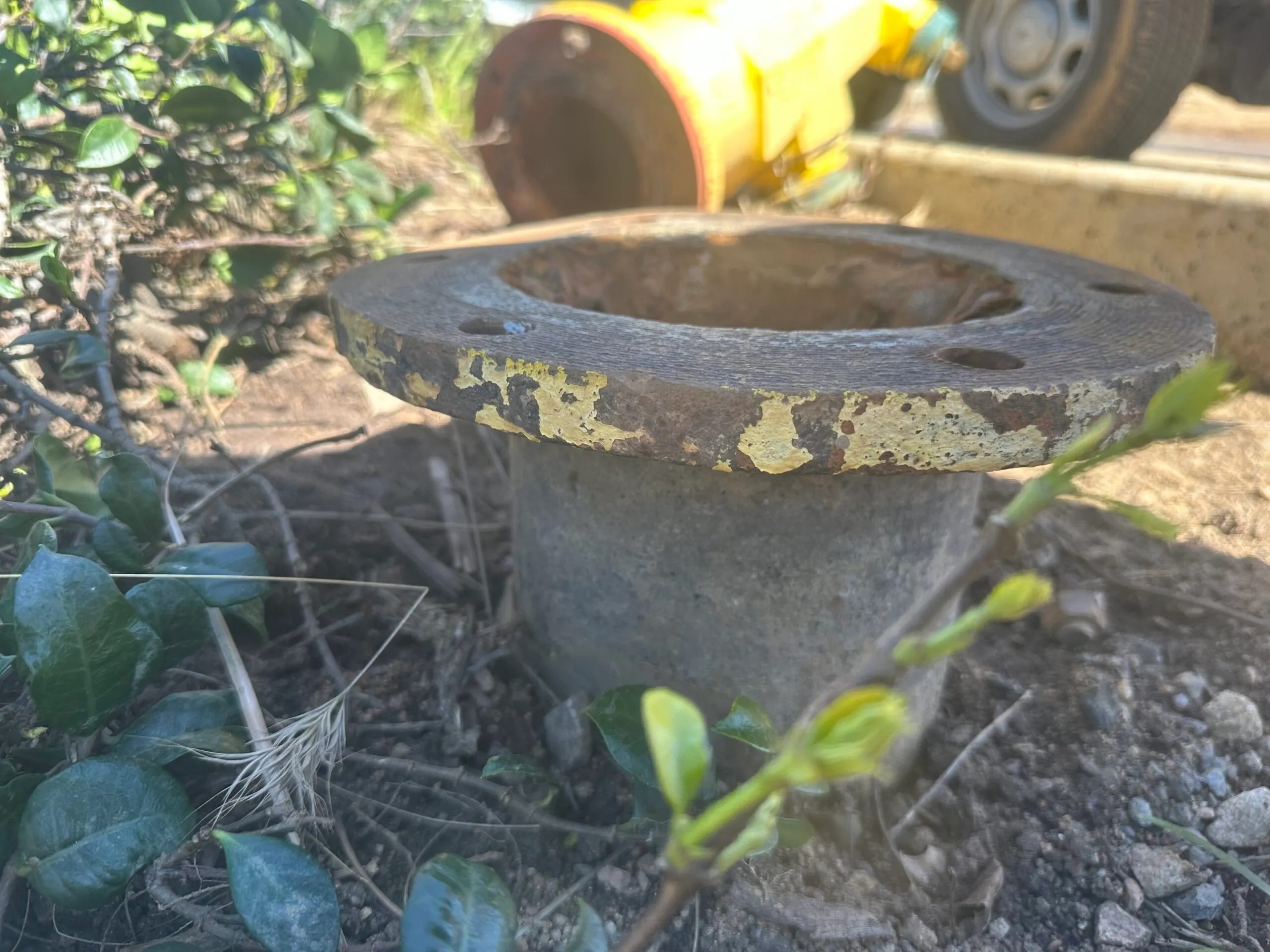 Rows of red fire extinguishers with labels in a storage area and a person handling one extinguisher in the background.