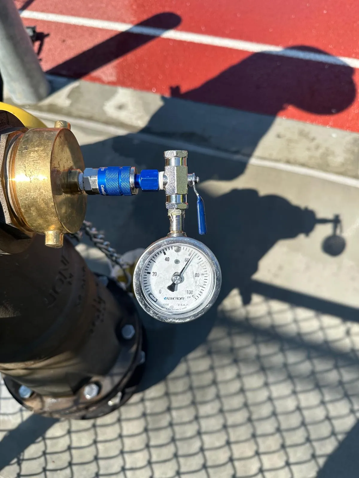 Person in navy shirt holding a red Amerex fire extinguisher with instruction label.