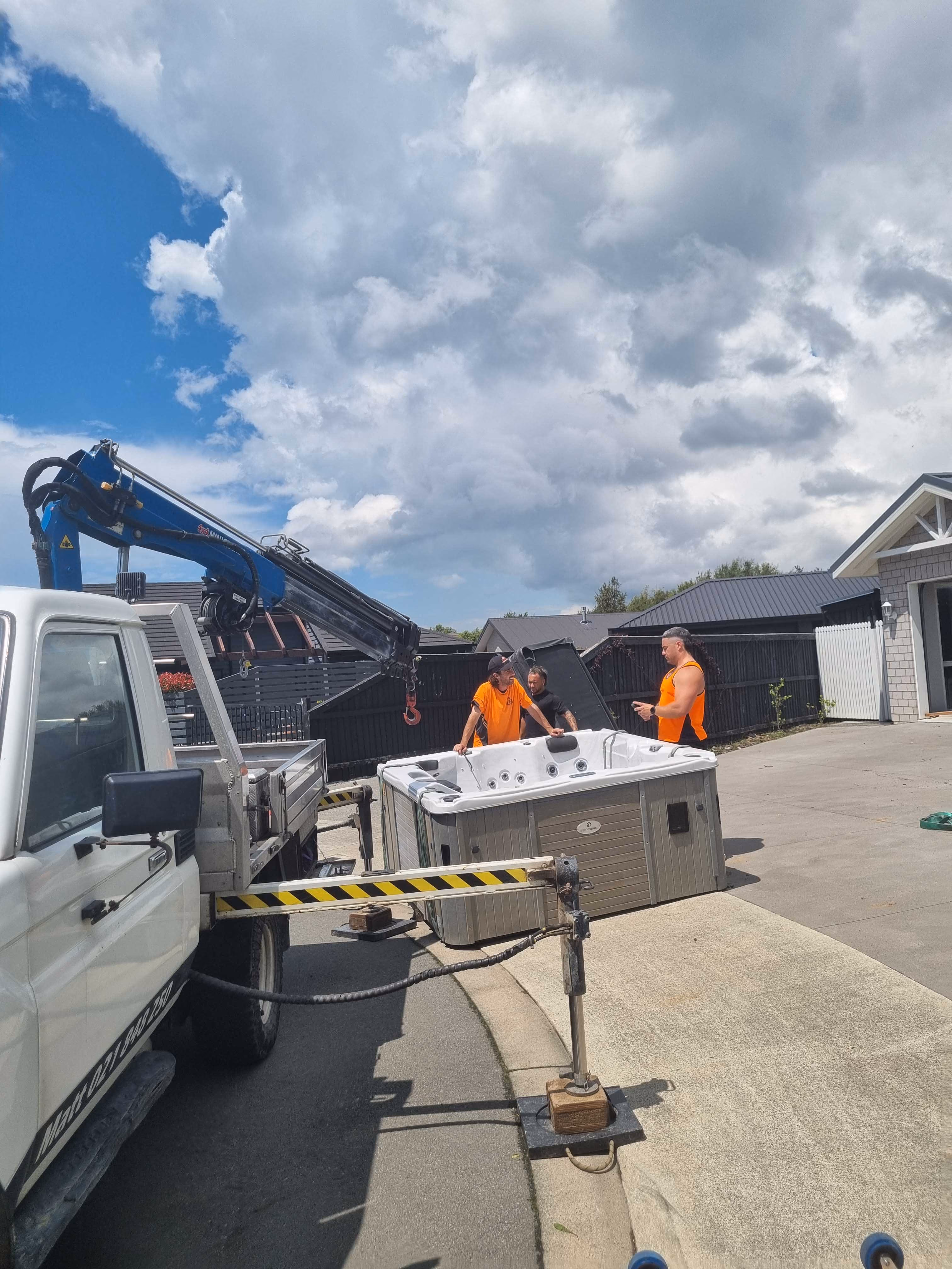 Manalift crew prepping spa for lifting