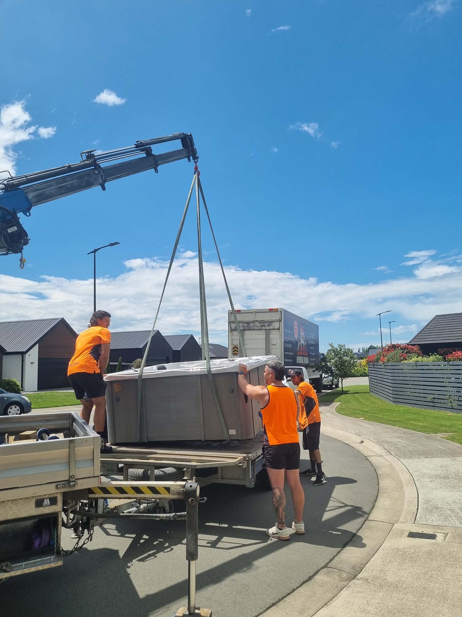 Hiab truck finishing lifting spa onto truck