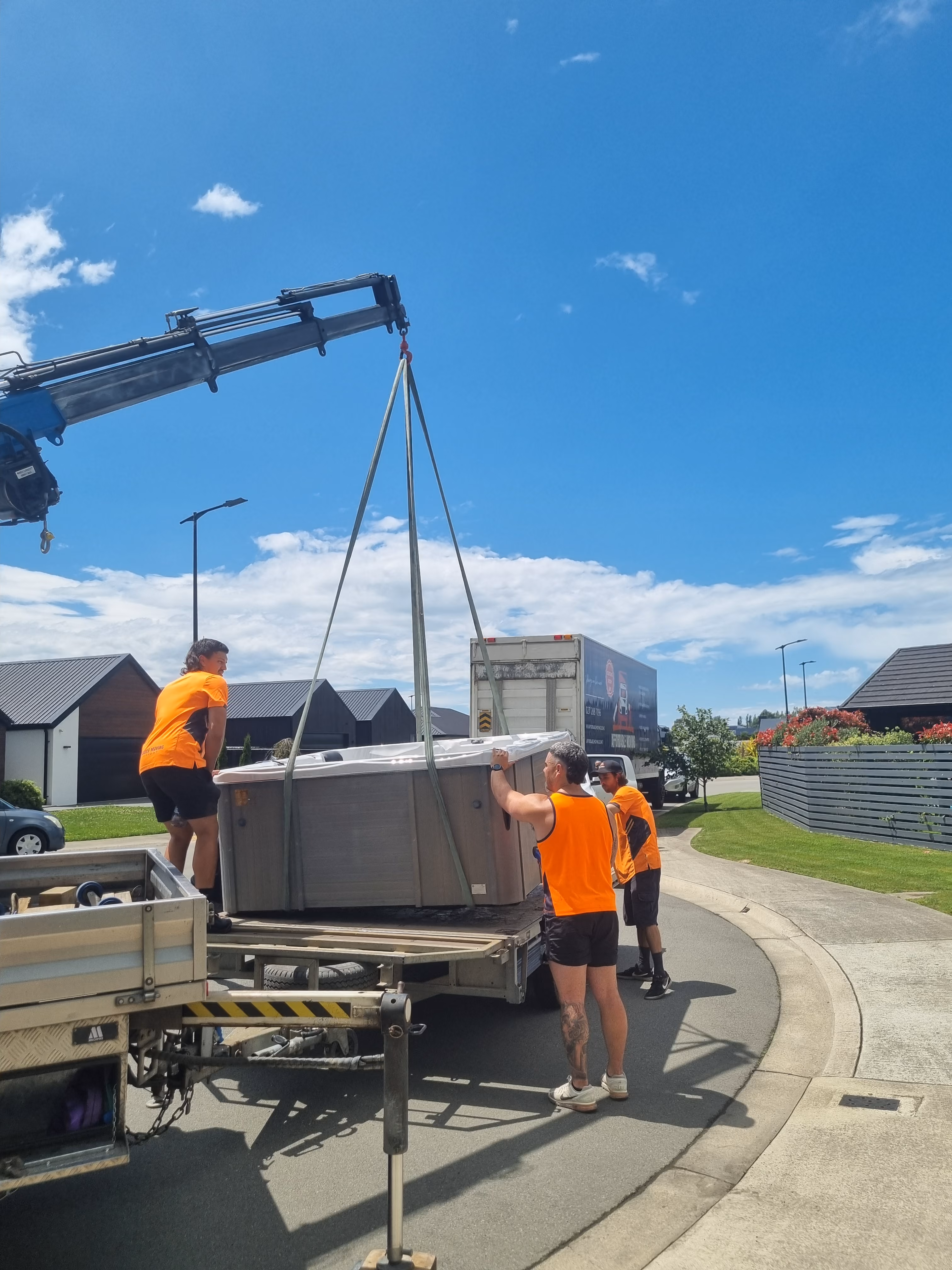 Hiab truck finishing lifting spa onto truck