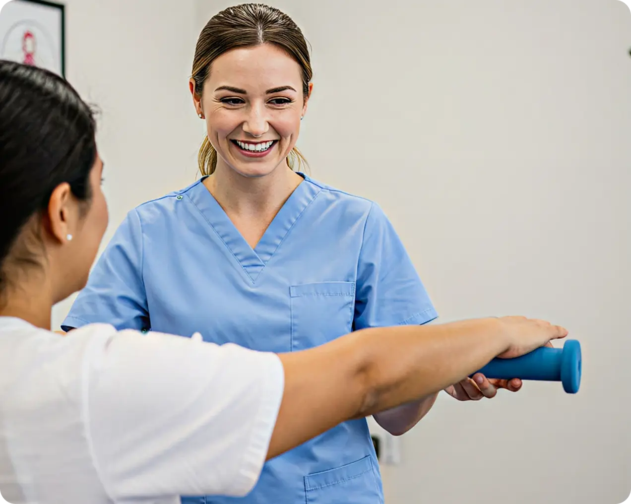 Healthcare professional in blue scrubs guiding a patient holding a blue dumbbell during rehab exercise.