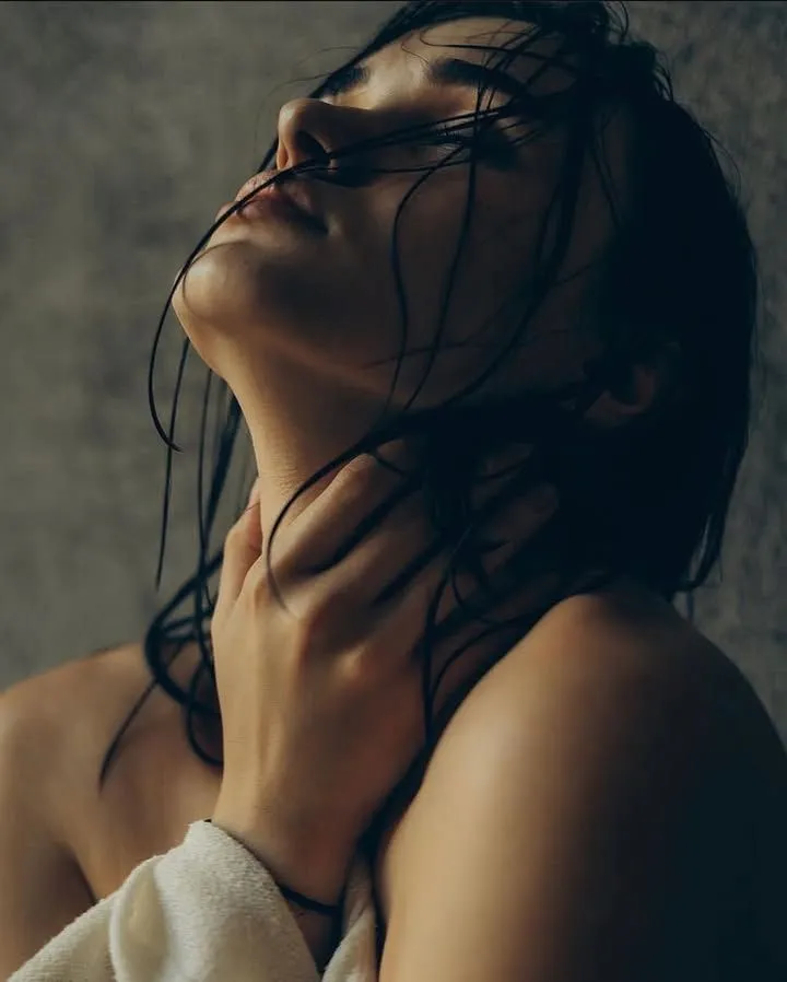 Woman touching her neck — start your consultation at 208 Regen & Aesthetics