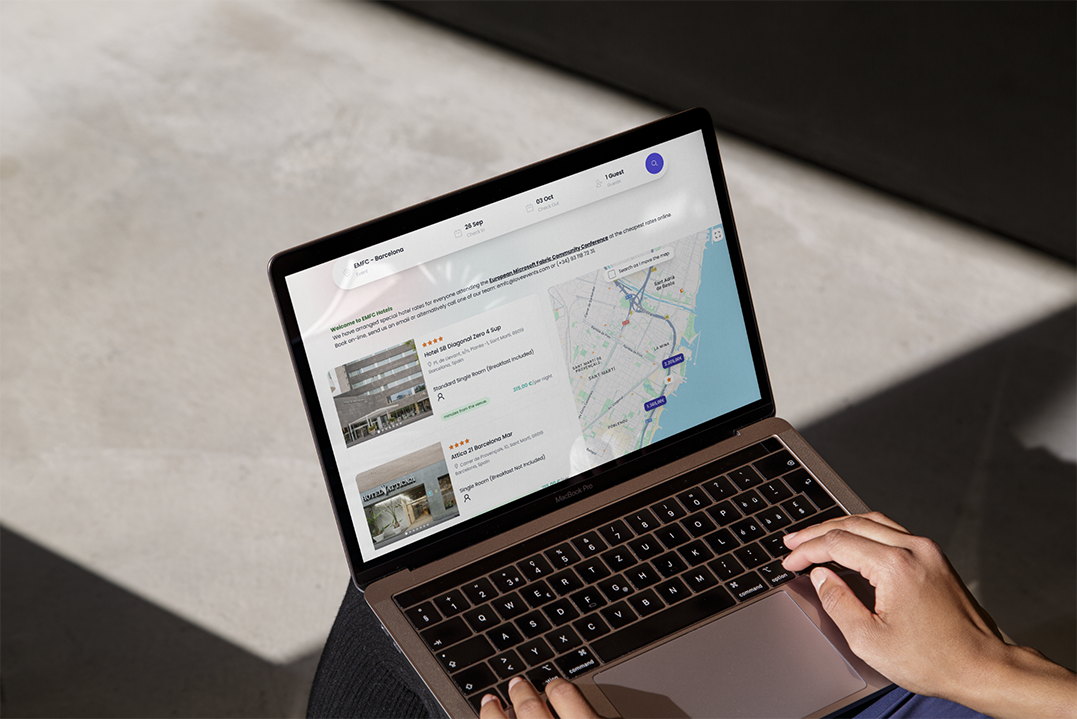 Event accommodation platform displayed on a laptop, showing booking options and location details for managed stays.