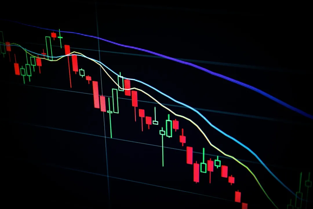 stock market candlestick chart on dark screen. Photo by Maxim Hopman on Unsplash