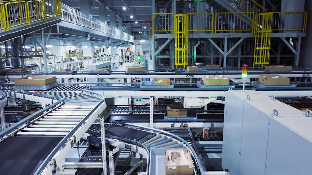 a factory filled with lots of machines and boxes. Photo by Hyundai Motor Group on Unsplash