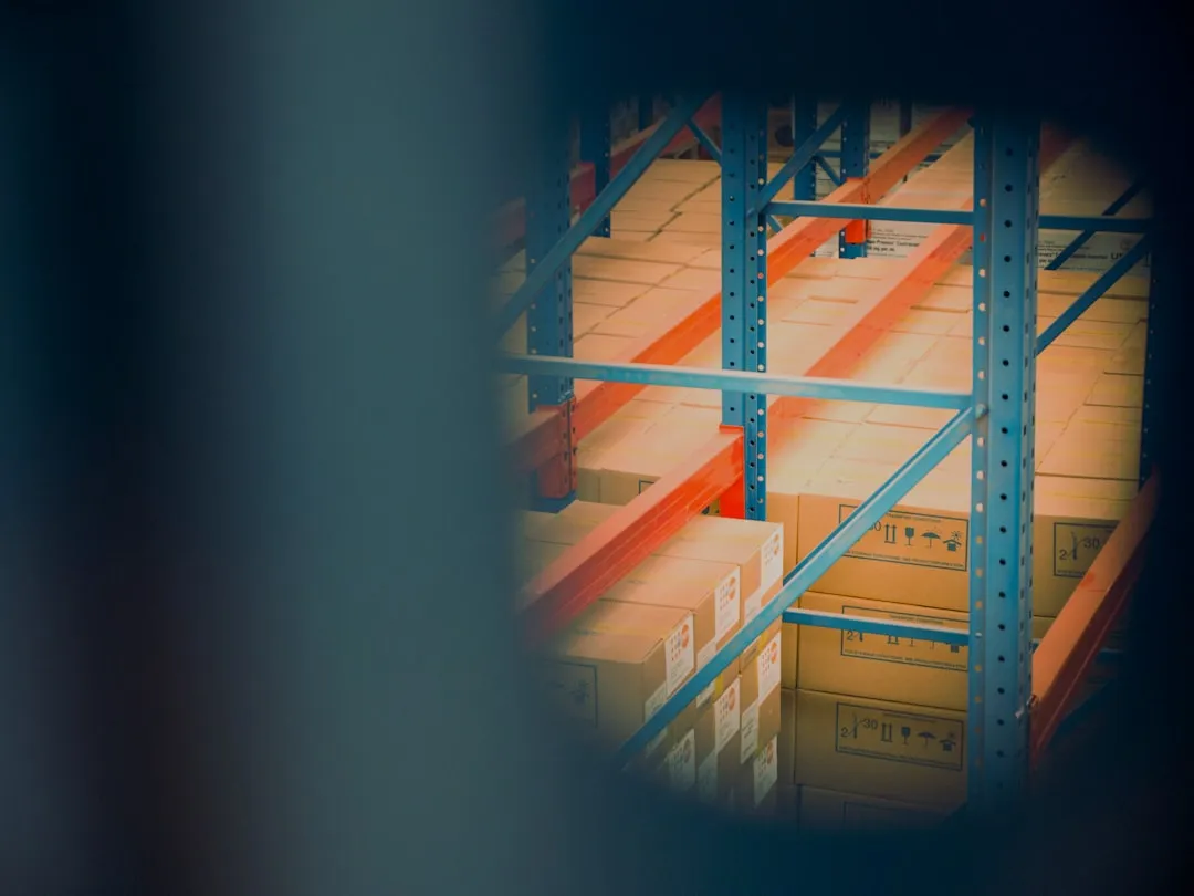 selective focus photography of brown boxes on grey shelf. Photo by Reproductive Health Supplies Coalition on Unsplash
