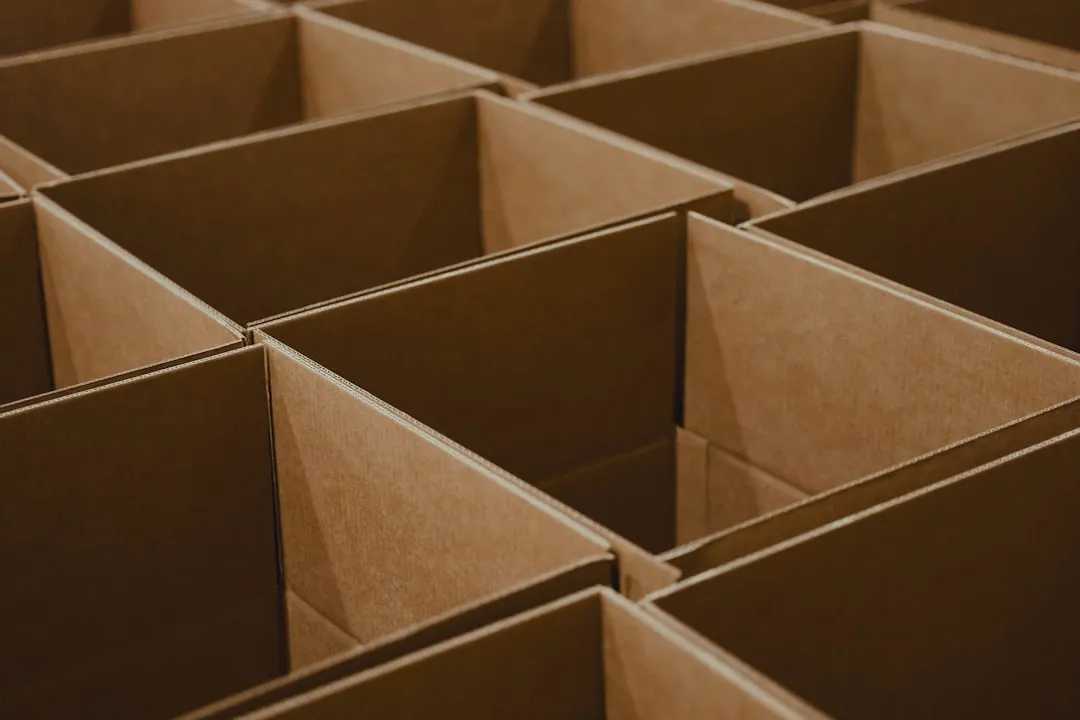 a lot of brown boxes that are open. Photo by Luke Heibert on Unsplash