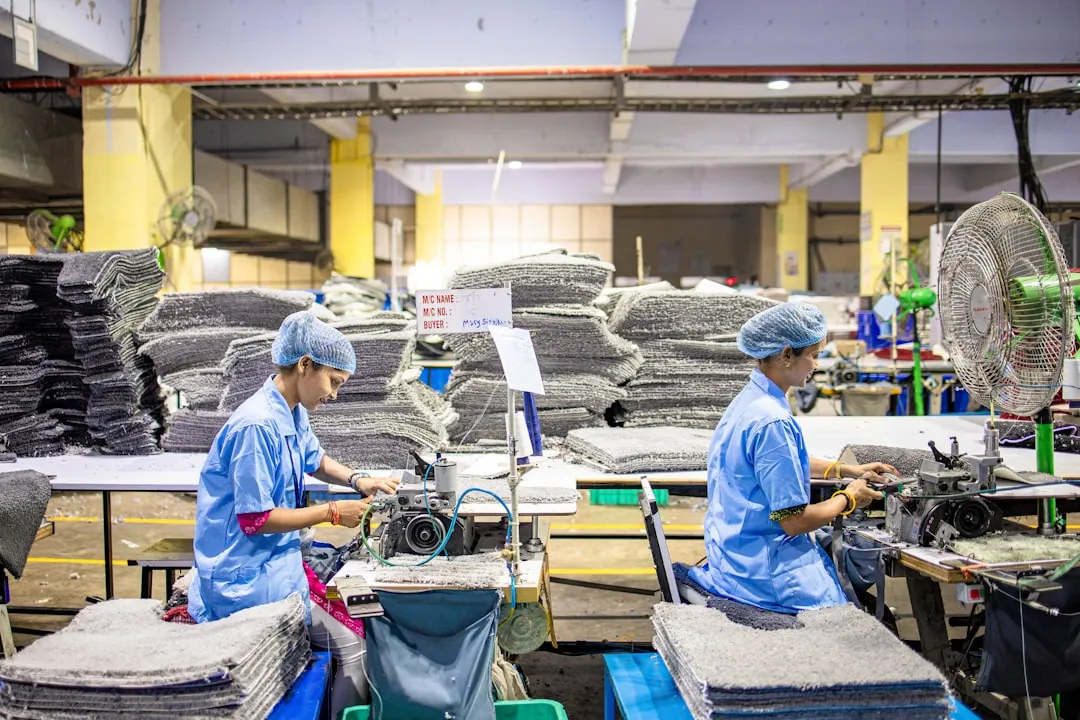 Workers operate machinery in a factory environment.. Photo by EqualStock on Unsplash