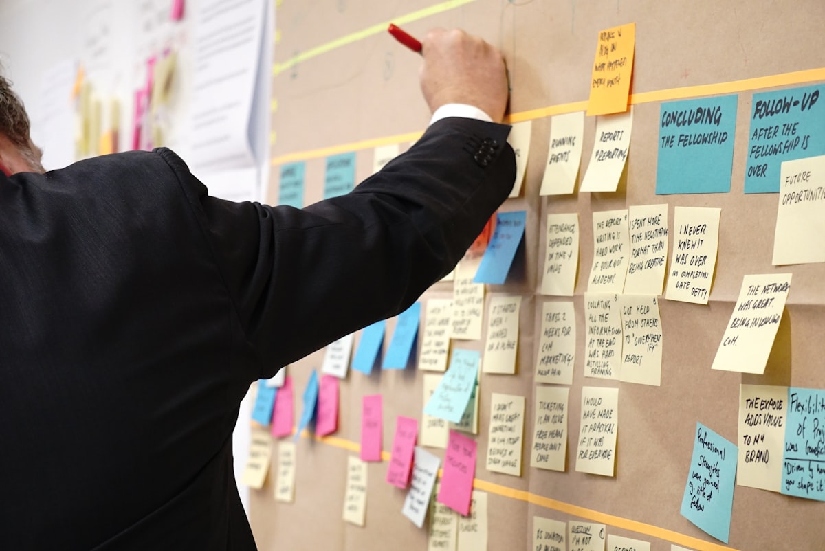 sticky notes on corkboard — Photo by Jo Szczepanska on Unsplash