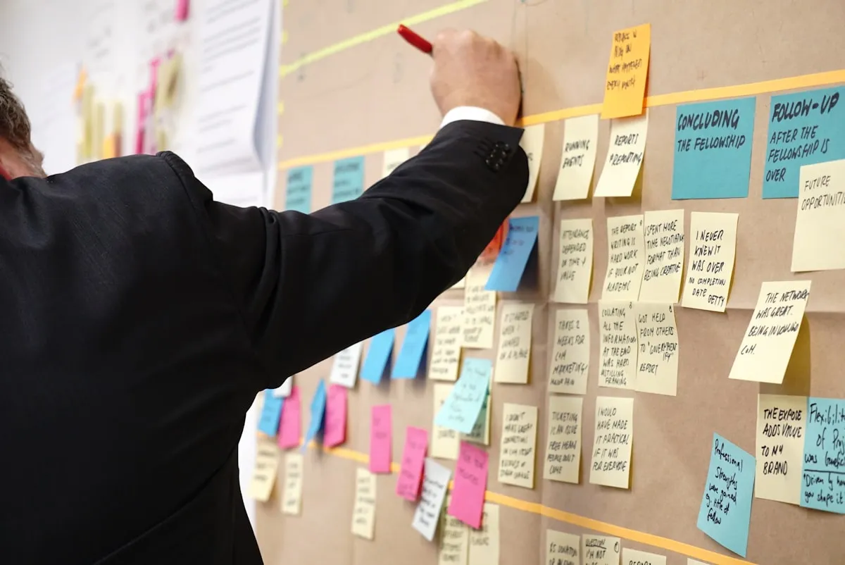 sticky notes on corkboard. Photo by Jo Szczepanska on Unsplash