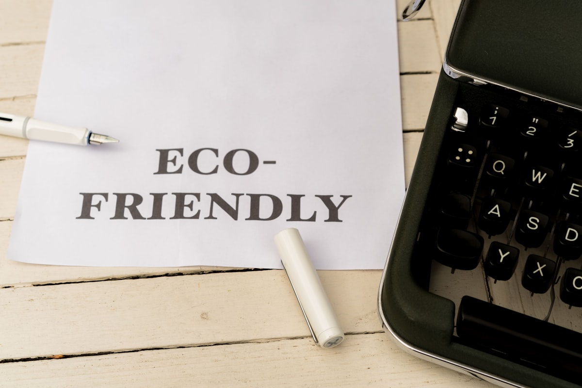 a piece of paper that says eco - friendly next to a typewriter — Photo by Markus Winkler on Unsplash