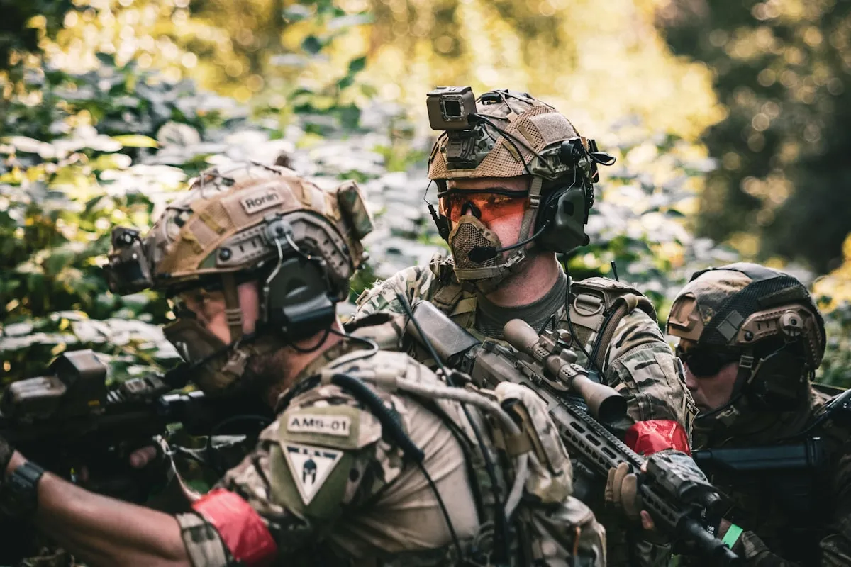 man in black and grey camouflage uniform wearing black helmet and black helmet. Photo by Daniel on Unsplash