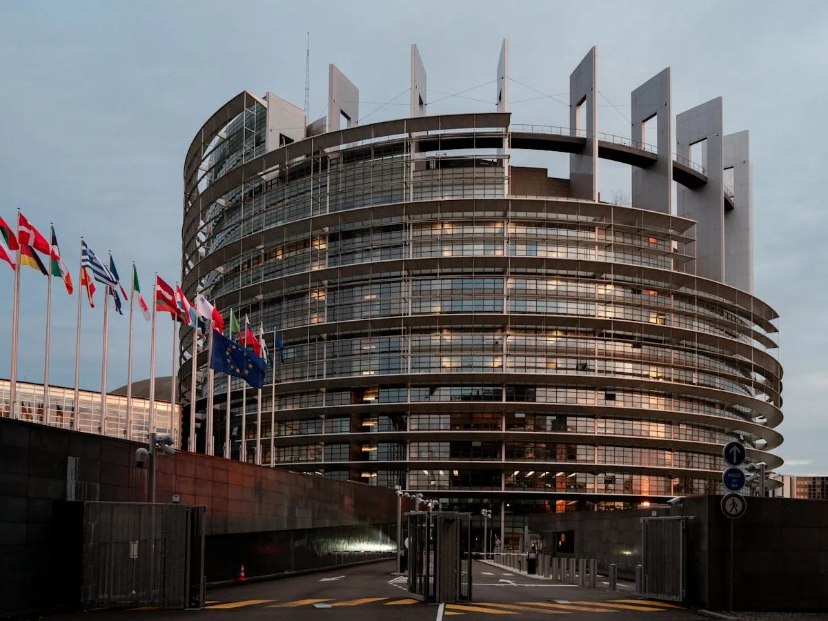 a large building with a lot of flags in front of it. Photo by Lukas S on Unsplash