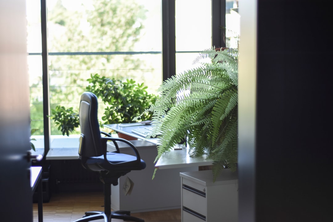 black leather rolling armchair near white wooden desk — Photo by Unknown Wong on Unsplash