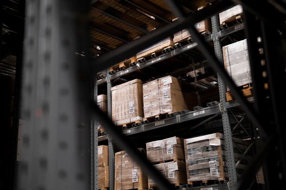 a warehouse filled with lots of boxes and pallets, Photo by Arum Visuals on Unsplash