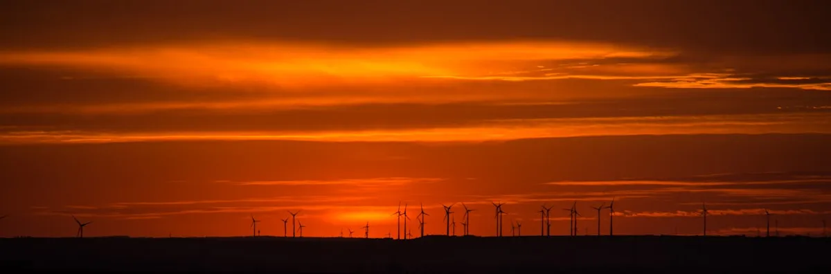 a group of wind turbines. Photo by Bernd Dittrich on Unsplash